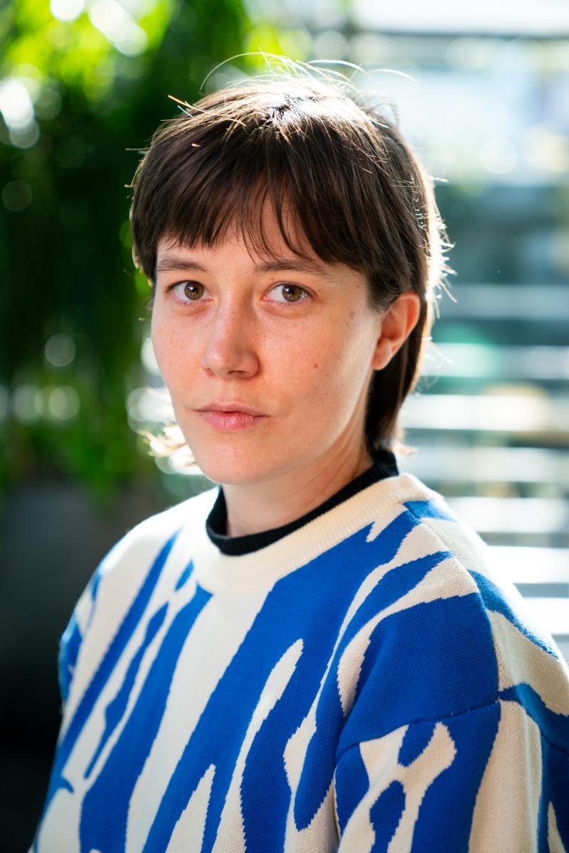 short-haired woman in blue sweater